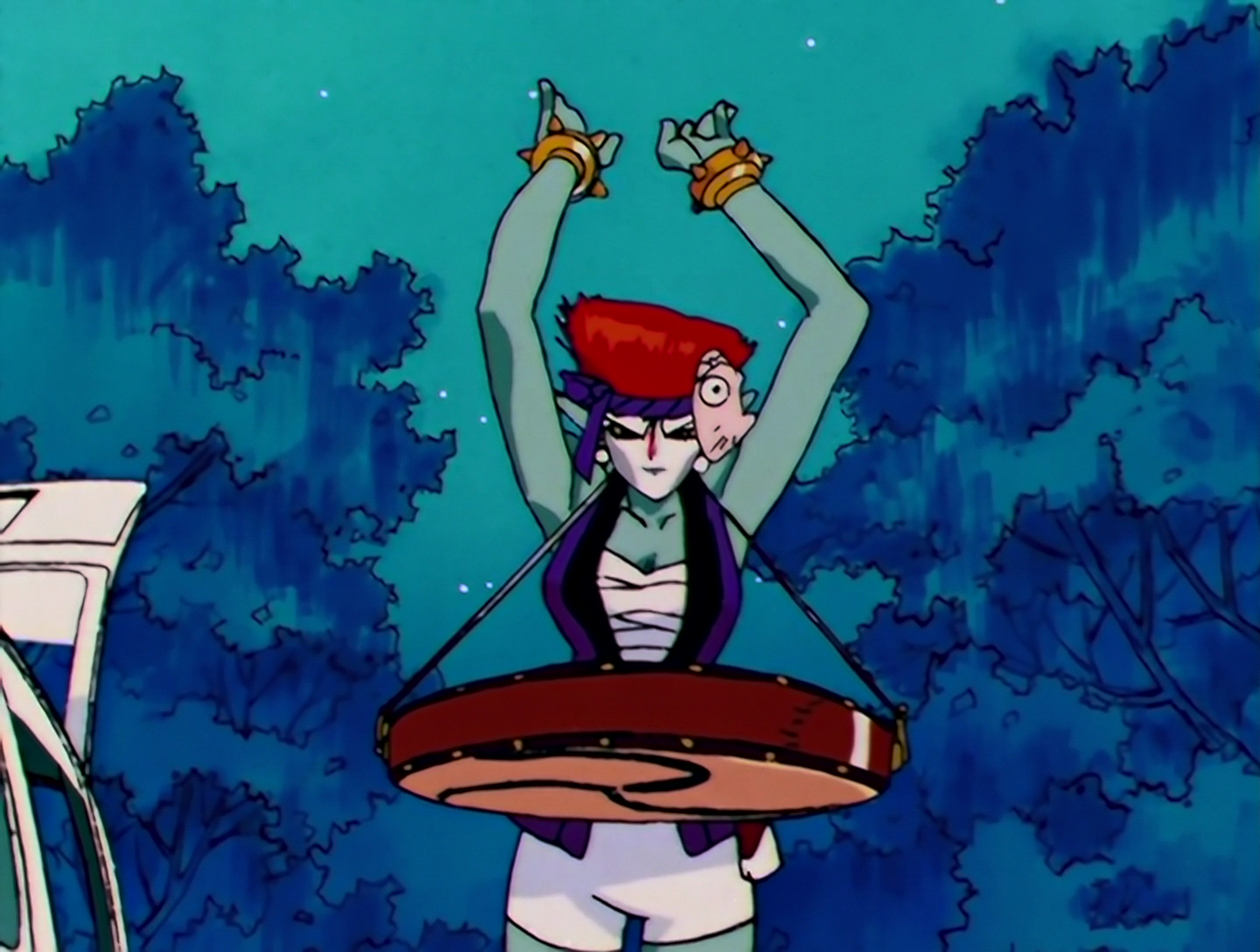 Soiya, a Daimon from Sailor Moon episode 103. She has turquoise skin, white makeup on her face, and spiked red hair. She’s wearing white binding with a purple happi and headband, plus a festival mask on the side of her head. She has a taiko drum secured in front of her and is holding her hands above it.